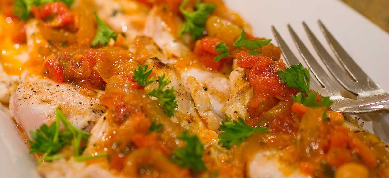 Chef-prepared chicken in a roasted tomato and pepper sauce