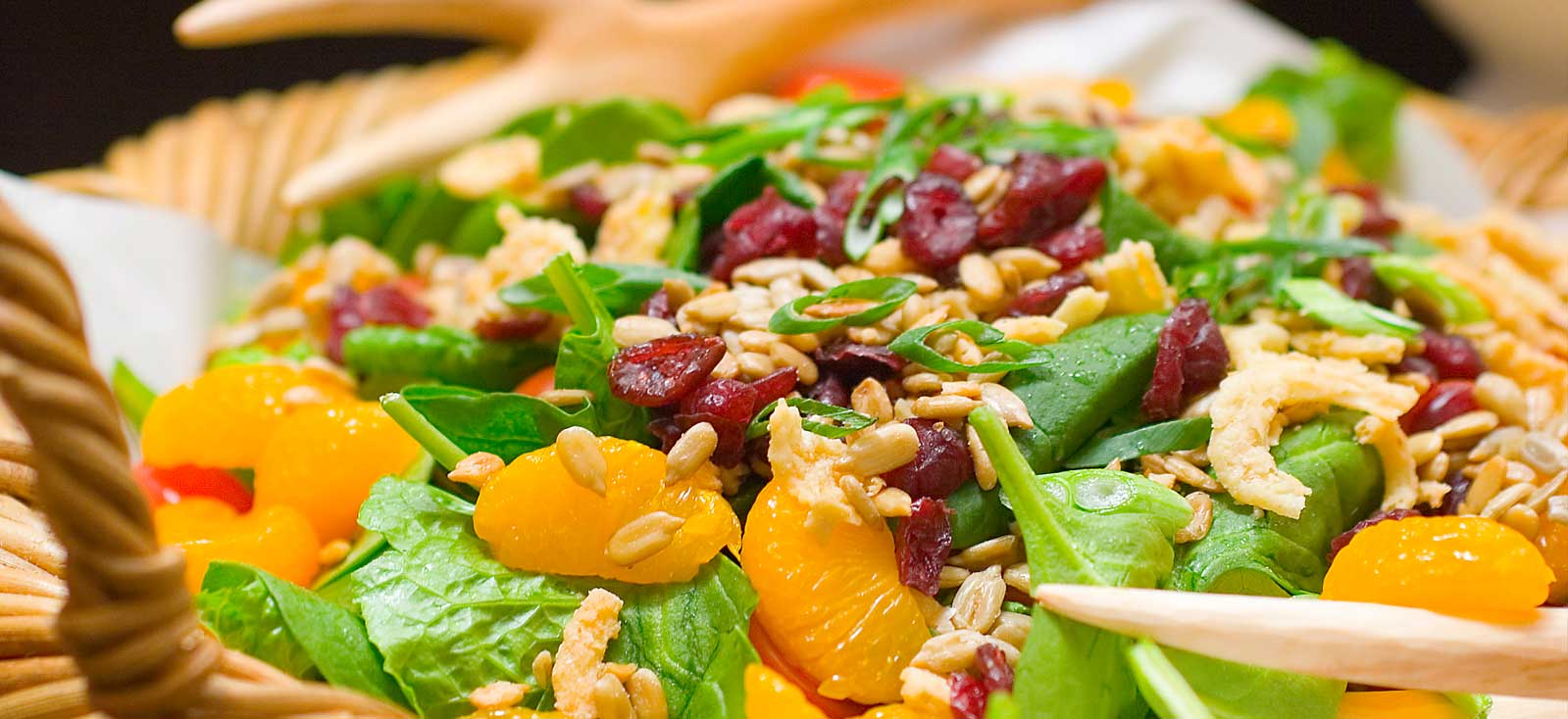 Fresh spinach salad with mandarin oranges, cranberries and sunflower seeds